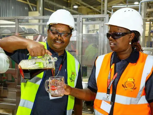 EABL Supply Chain Director Patrick Kamugi pours KBL Managing Director Jane Karuku a drink