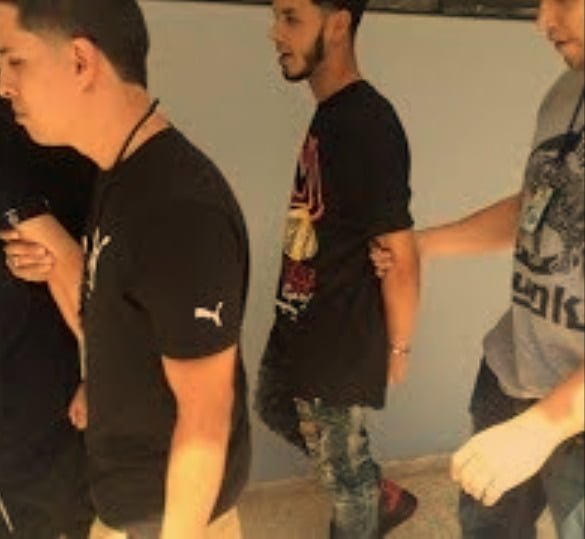 An image of Anuel AA during his arrest for illegal possession of firearms in April 2016.