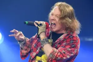 An image of Axl Rose performing in a stage