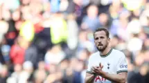 An image of Harry Kane appreciating fans after a match in tottenham jersey