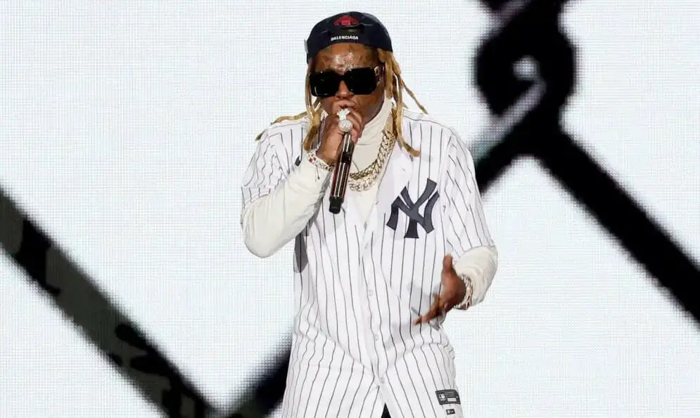 An image of Lil Wayne performing in a stage at a show