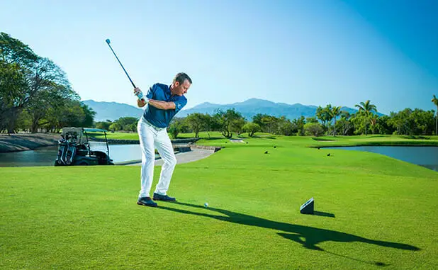 Image: A golfer in the midst of a precise golf swing.