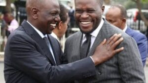 An image of President William Ruto laughing alongside Governor Johnson Sakaja