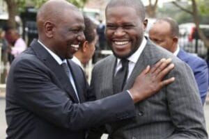 An image of President William Ruto laughing alongside Governor Johnson Sakaja