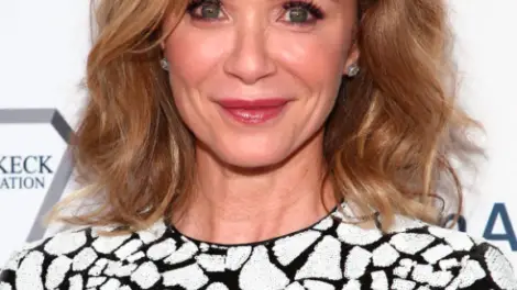 Lauren Holly smiling at the camera.