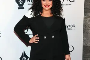 A vibrant image of Michelle Buteau, the comedian, in a lively pose.